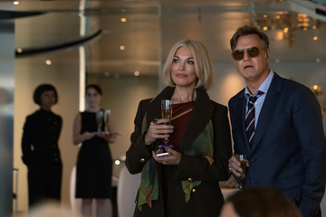 social gathering with elegantly dressed individuals holding drinks