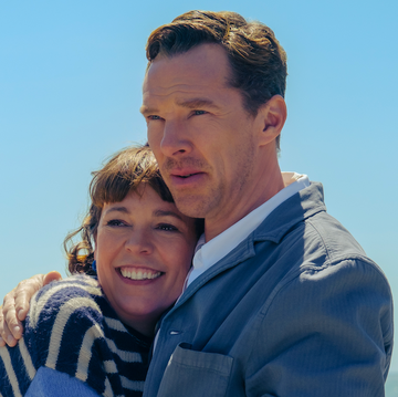 couple embracing on a beach with a calm sea in the background couple embracing on a beach with a calm sea in the background