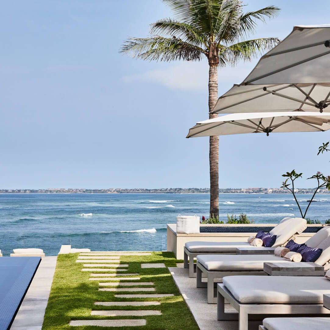 lounge area beside an infinity pool overlooking the ocean lounge area beside an infinity pool overlooking the ocean