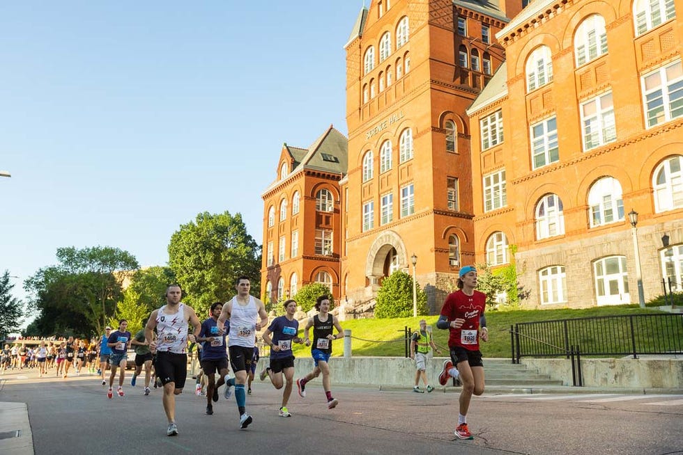 participants running in a race near a historic brick building midwest financial group madison mini marathon runner's world magazine