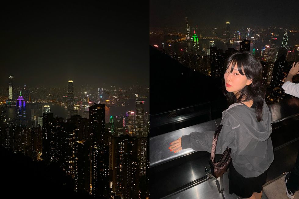 a person leaning on a railing overlooking a city at night