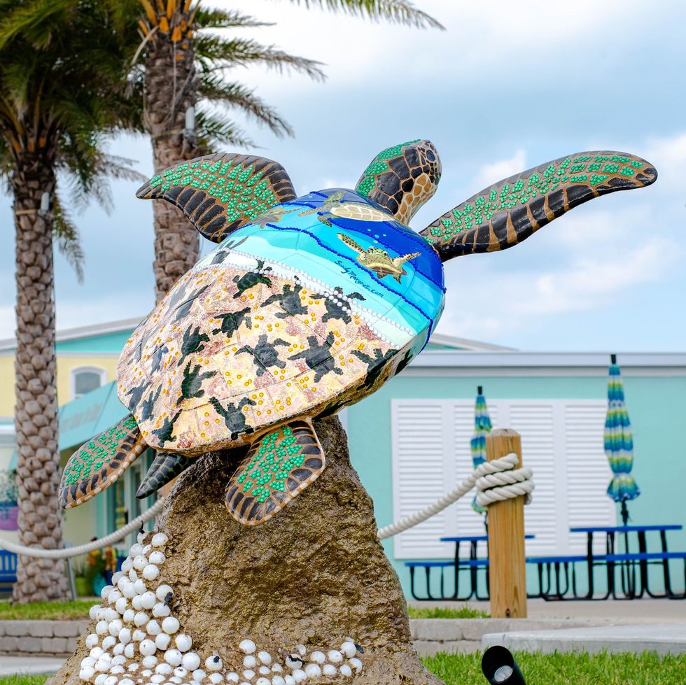 colorful painted sea turtle sculpture in front of a store on south padre island