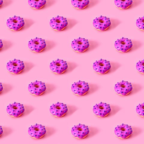seamless pattern of glazed donuts on pink background