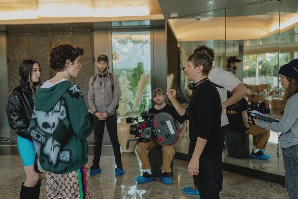 A group of people in a filming environment discussing a scene