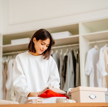 season clothes change in a wardrobe. calm woman change and arranging clothes for the new season