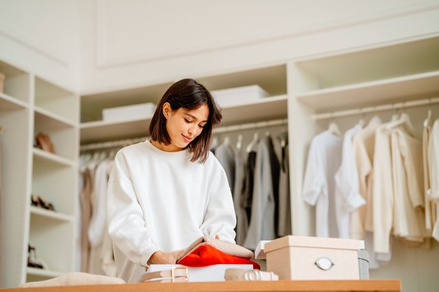season clothes change in a wardrobe. calm woman change and arranging clothes for the new season
