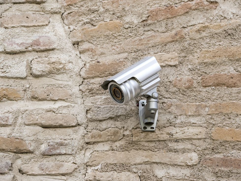 security camera on an ancient wall of bricks
