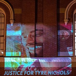 a photo of tyre nichols projected onto a building
