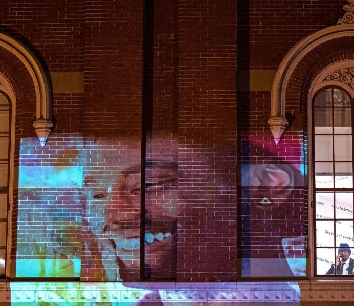 a photo of tyre nichols projected onto a building
