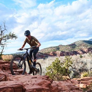 a man riding a bike on a rocky terrain