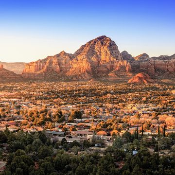 birds eye view to the city of sedona, arizona and the red rocks at sunset