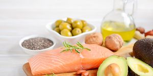 selection of healthy unsaturated fats, omega 3 fish　avocado　 olives nuts and seeds