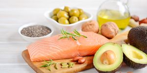 selection of healthy unsaturated fats, omega 3 fish　avocado　 olives nuts and seeds