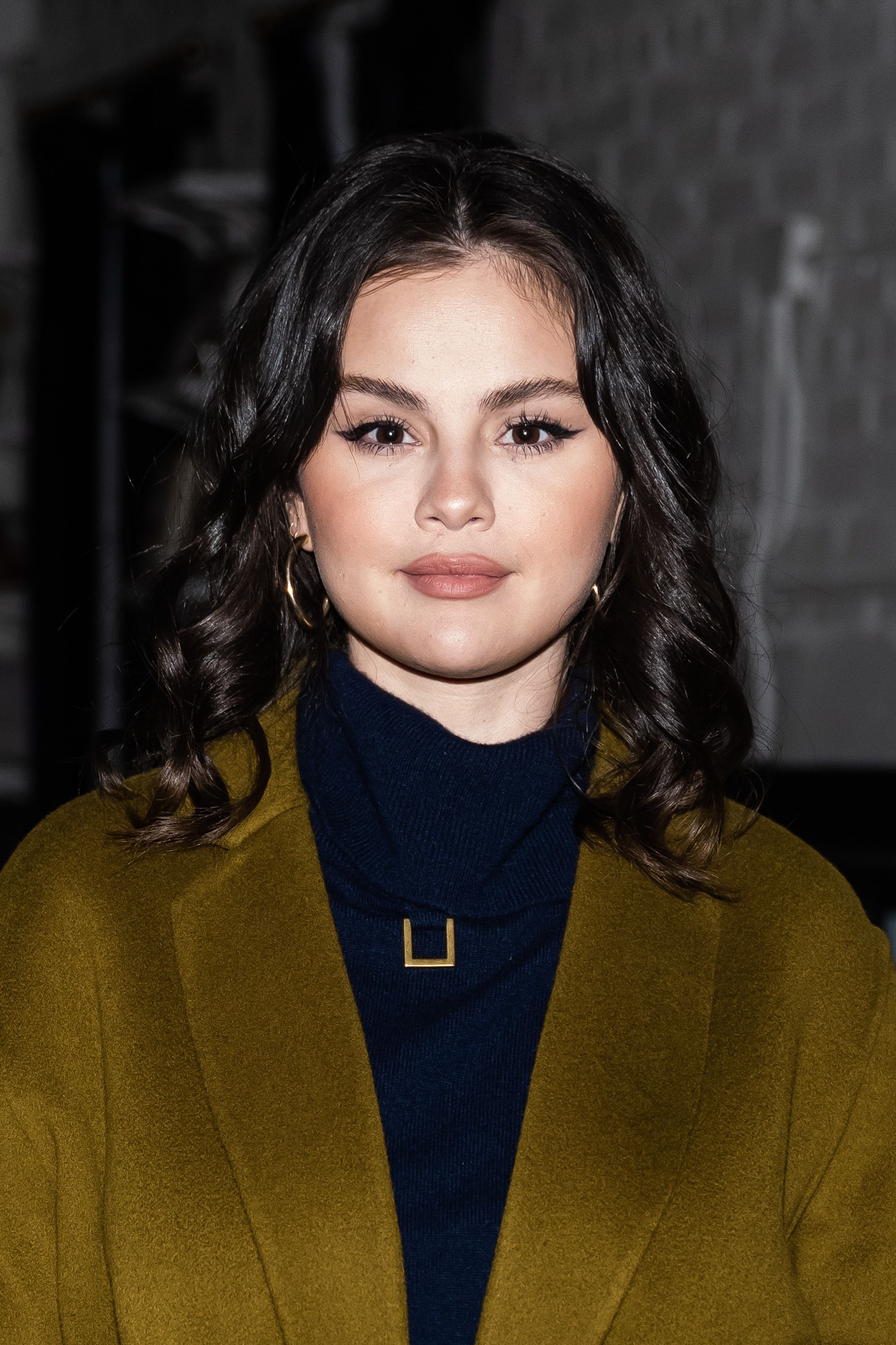 Selena Gomez Wears a Navy Coat and Balmain Sweater Dress