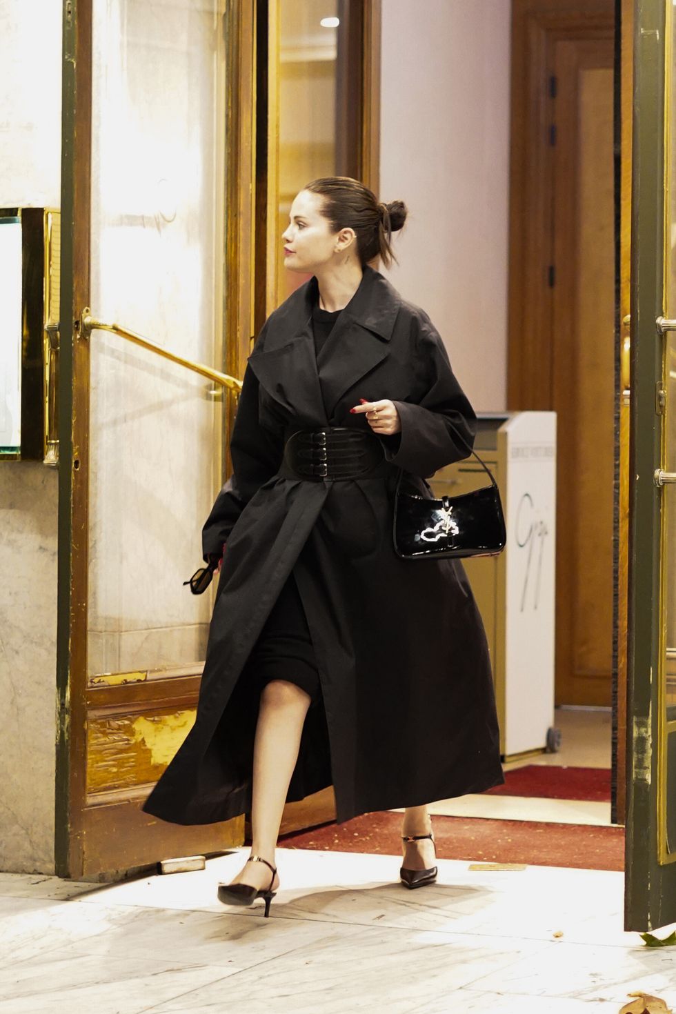 Selena Gomez Is Chic in Black Belted Coat and Dress in Paris