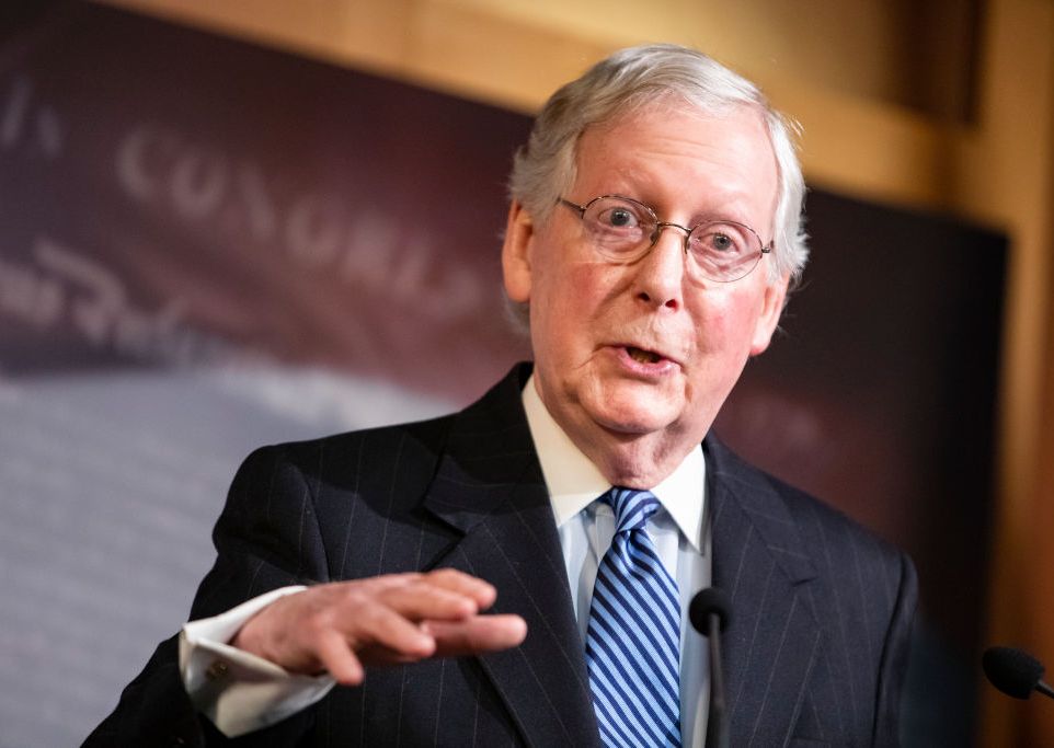 mitch mcconnell gesturing with his hand as he talks at a podium