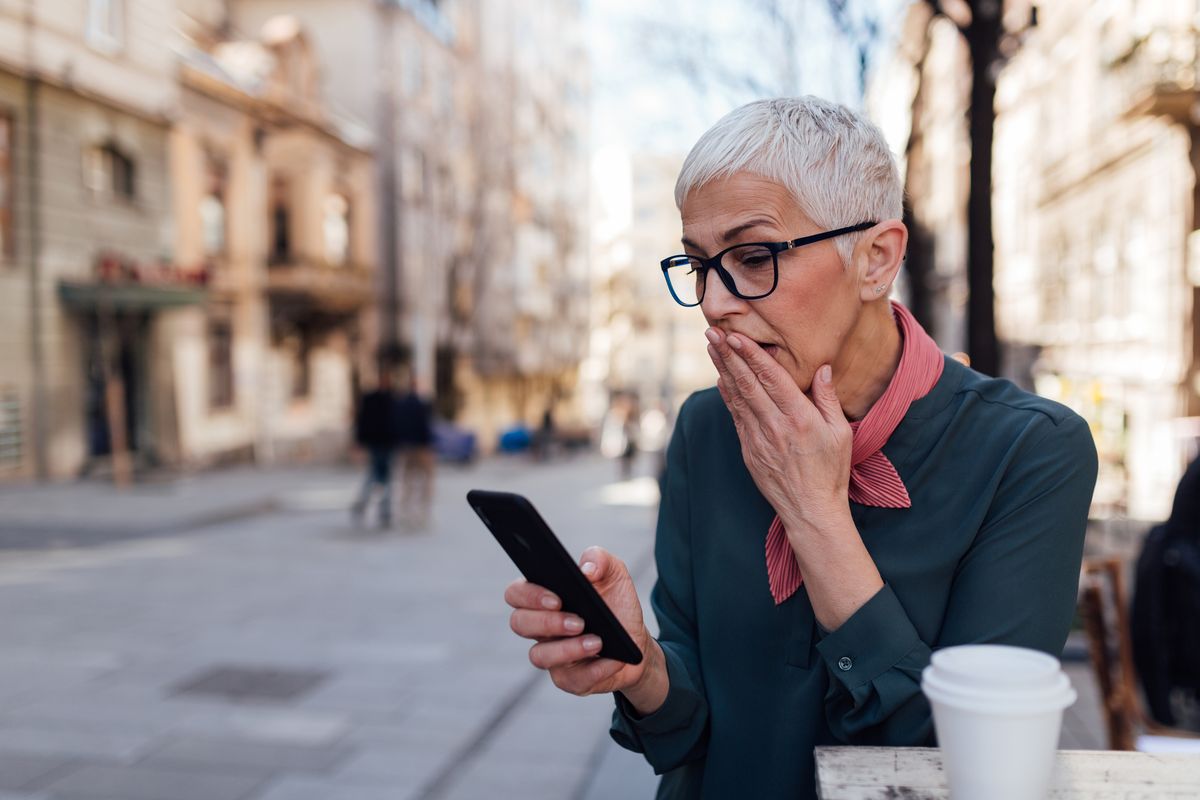 senior caucasian woman with gray hair using a smart phone