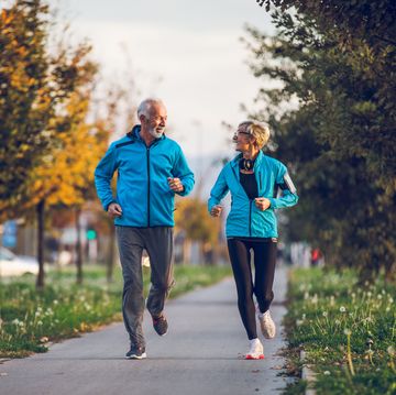 Senior couple in sports clothing jogging together