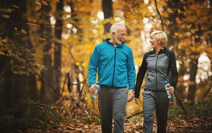 senior couple walking in a forest