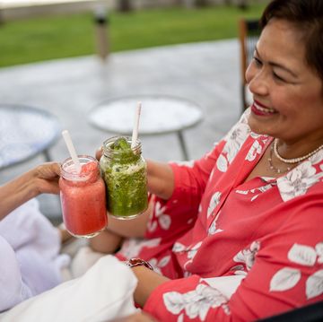 senior female friends making a toast at a resort outdoors