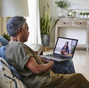 senior female patient taking online consultation with doctor through laptop at home