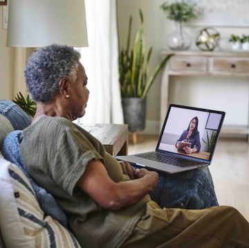 senior female patient taking online consultation with doctor through laptop at home