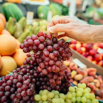 senior man choosing grapes at a farmer's market