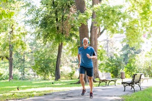 senior man is running in the park