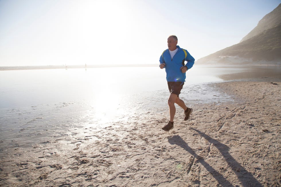 senior man running on beach