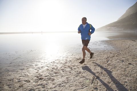 senior man running on beach