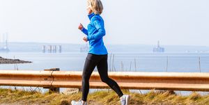 Senior woman jogging, Cromarty Firth, Scotland