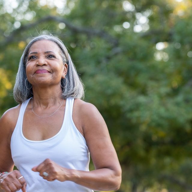 senior woman jogging in public park