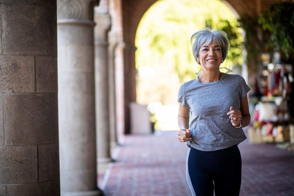 senior woman jogging in the city