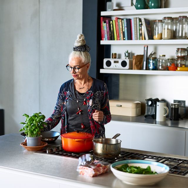https://hips.hearstapps.com/hmg-prod/images/senior-woman-making-meal-at-home-with-fresh-royalty-free-image-1672125149.jpg?crop=0.702xw:1.00xh;0.111xw,0&resize=640:*