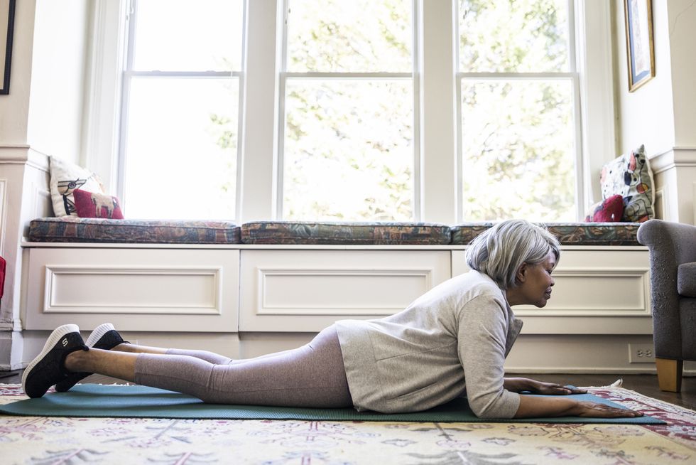 senior woman stretching at home