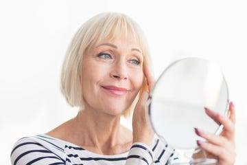 Senior woman touching her soft face skin