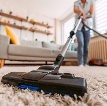 senior woman vacuuming her apartment