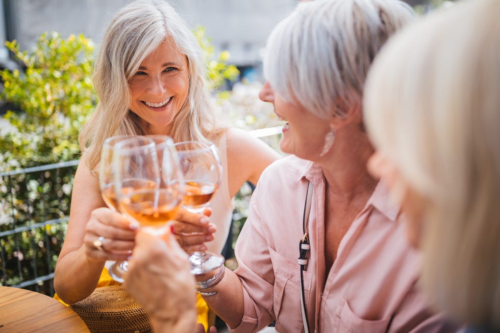 senior women on holidays toasting with wine during wine tasting