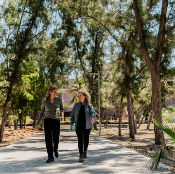 senior women talking and walking thorugh the public park