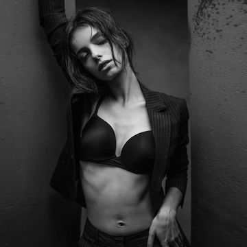 sensual young woman posing in jacket and lingerie