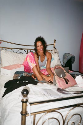 serena morris sitting on a bed