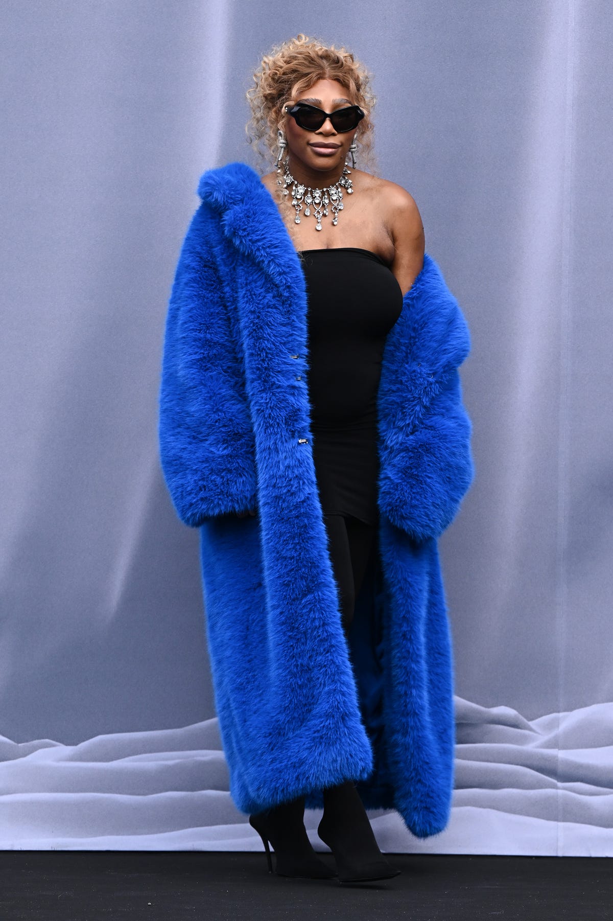 Serena Williams wears a blue coat at Paris Fashion Week