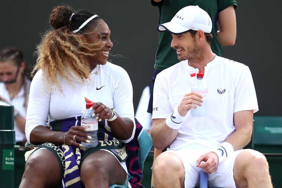 serena williams and andy murray smile at each other while sitting on the side of a tennis court, each holds a water bottle