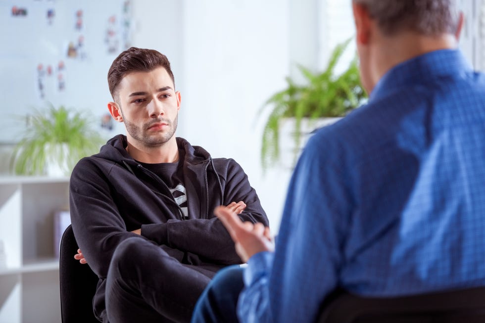 serious university student listening to therapist