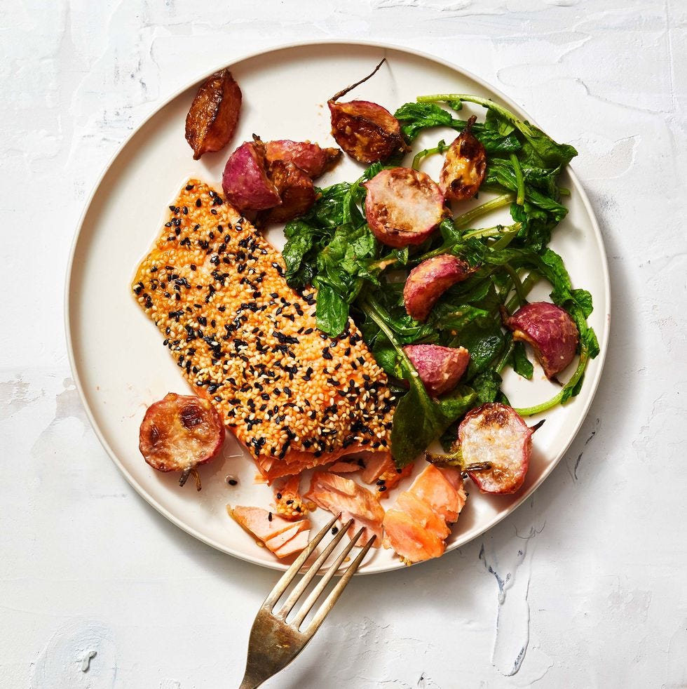 sesame crusted salmon with miso roasted radishes on a white plate