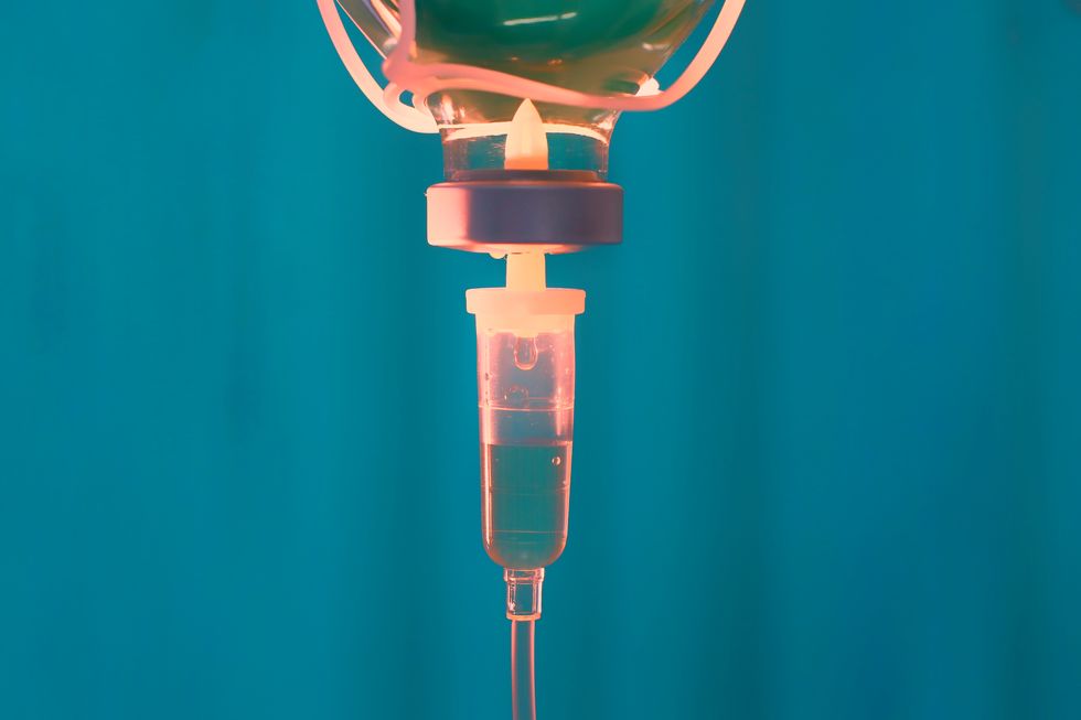 IV set fluid intravenous drop saline drip hospital room,Medical Concept,treatment emergency and injection drug infusion care chemotherapy, concept.blue light background,selective focus stock photo