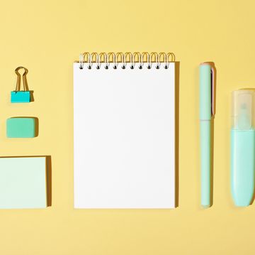 back to school quotes  organized flat lay of notepad, writing utensils, sticky notes and binder clip