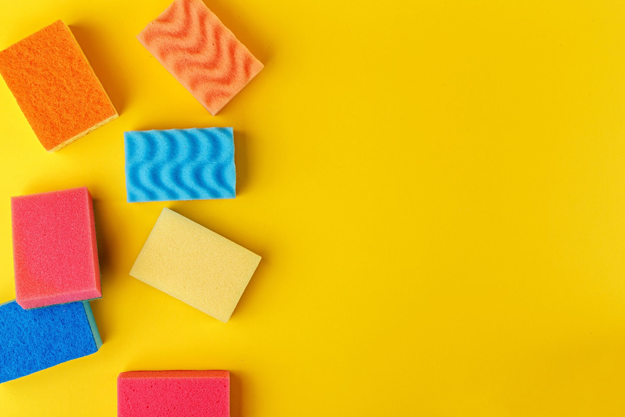 Set multi-colored sponges on a yellow background