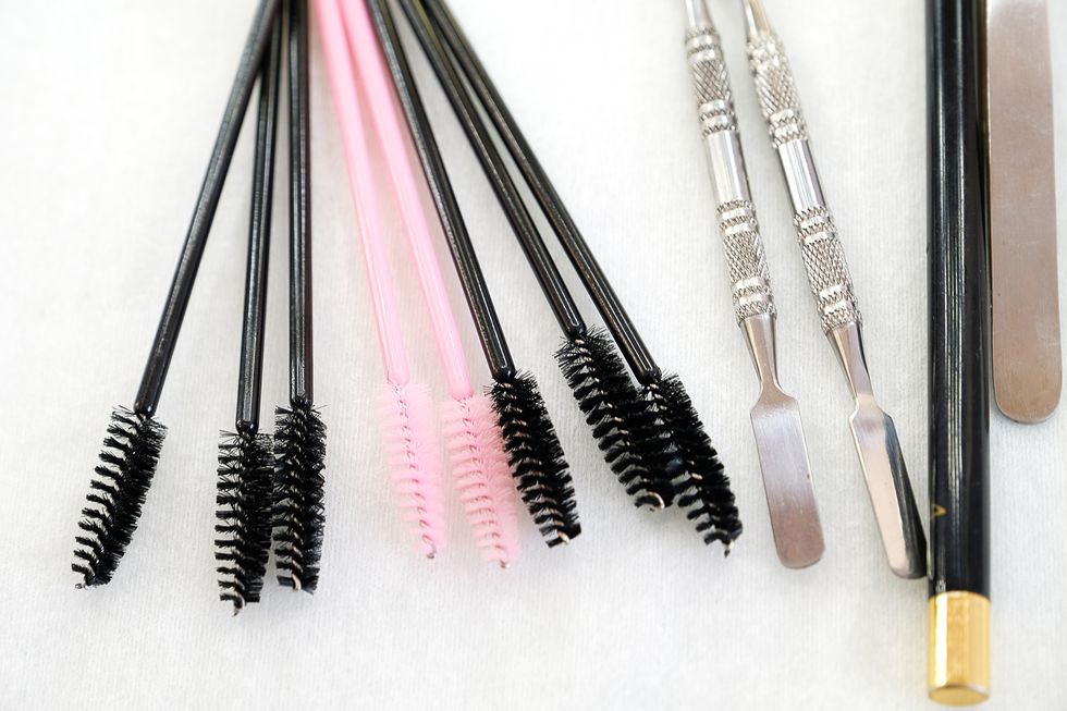 a set of brushes and pencil makeup artist for professional makeup in front of a mirror in a beauty salon, the concept of cosmetology, modeling and correction of the eyebrow line, self care