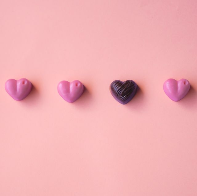 set of hearts shaped chocolates on pink background